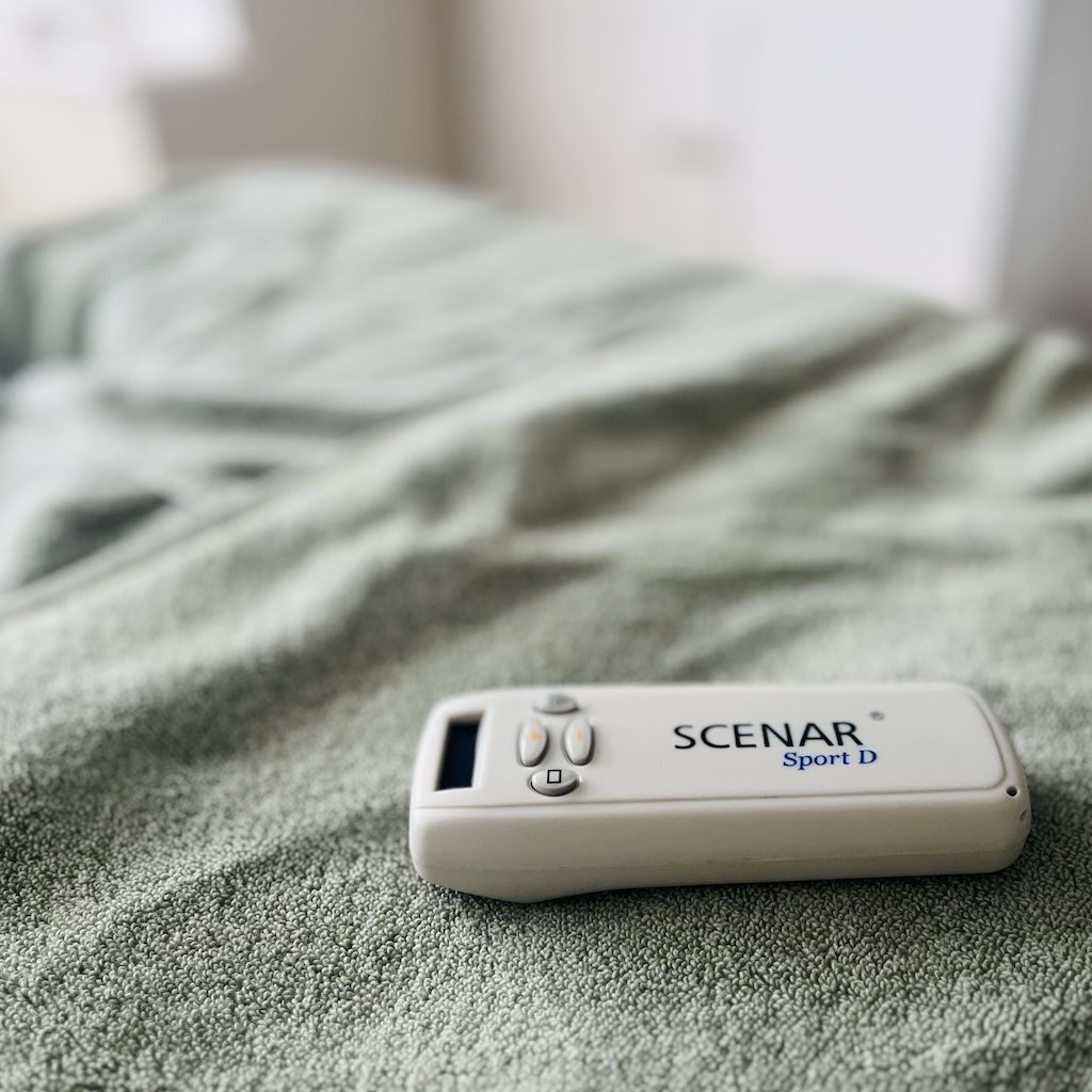 SCENAR Therapy device on massage table